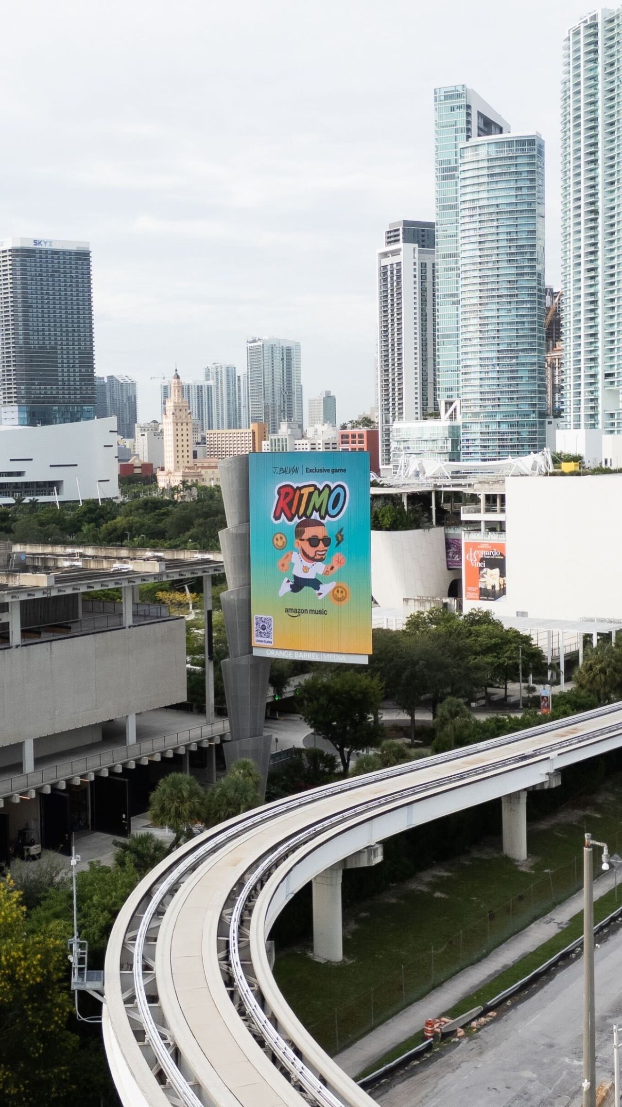 Ritmo billboard in Brickell, Miami — featuring J Balvin character above the RITMO logo, Amazon Music branding, and a QR code.
